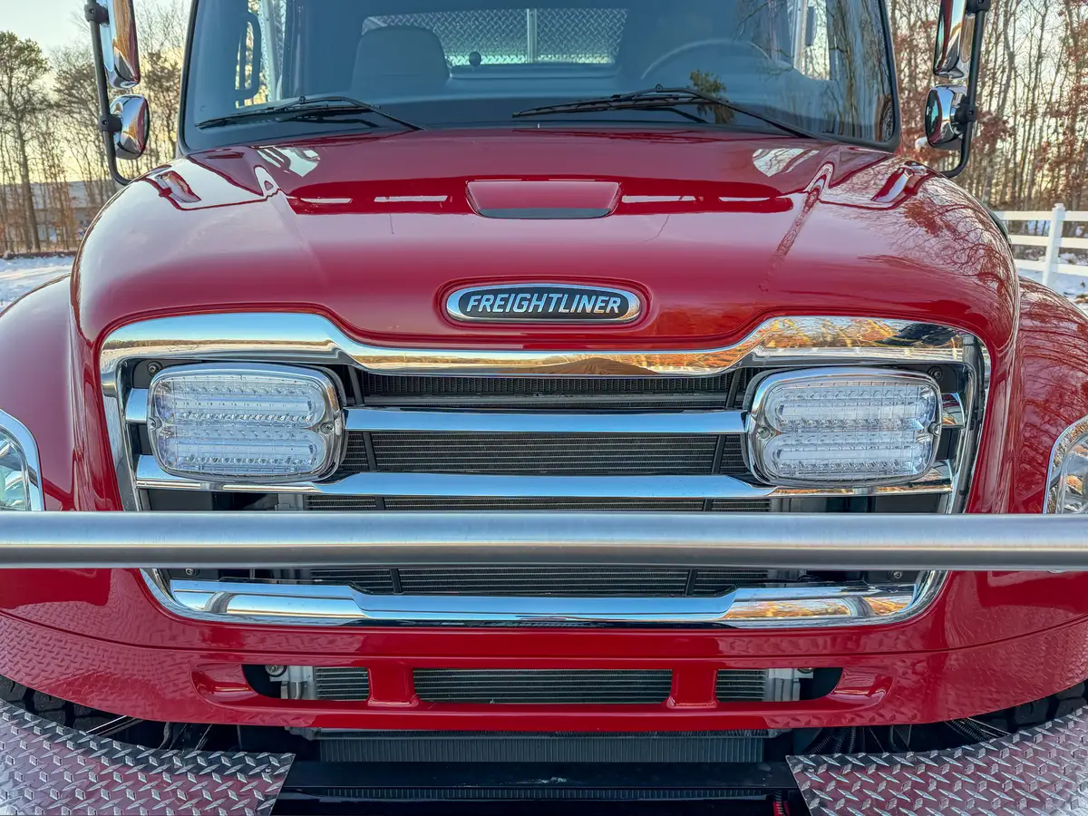 Front-right corner detail with monitor mount, bumper corner, and front tire.