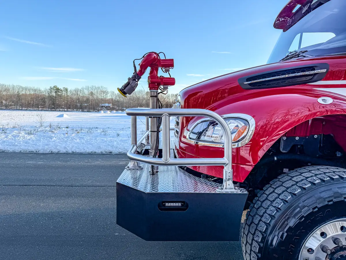 Close-up of side step assembly, fuel tank, and edge of pump panel.