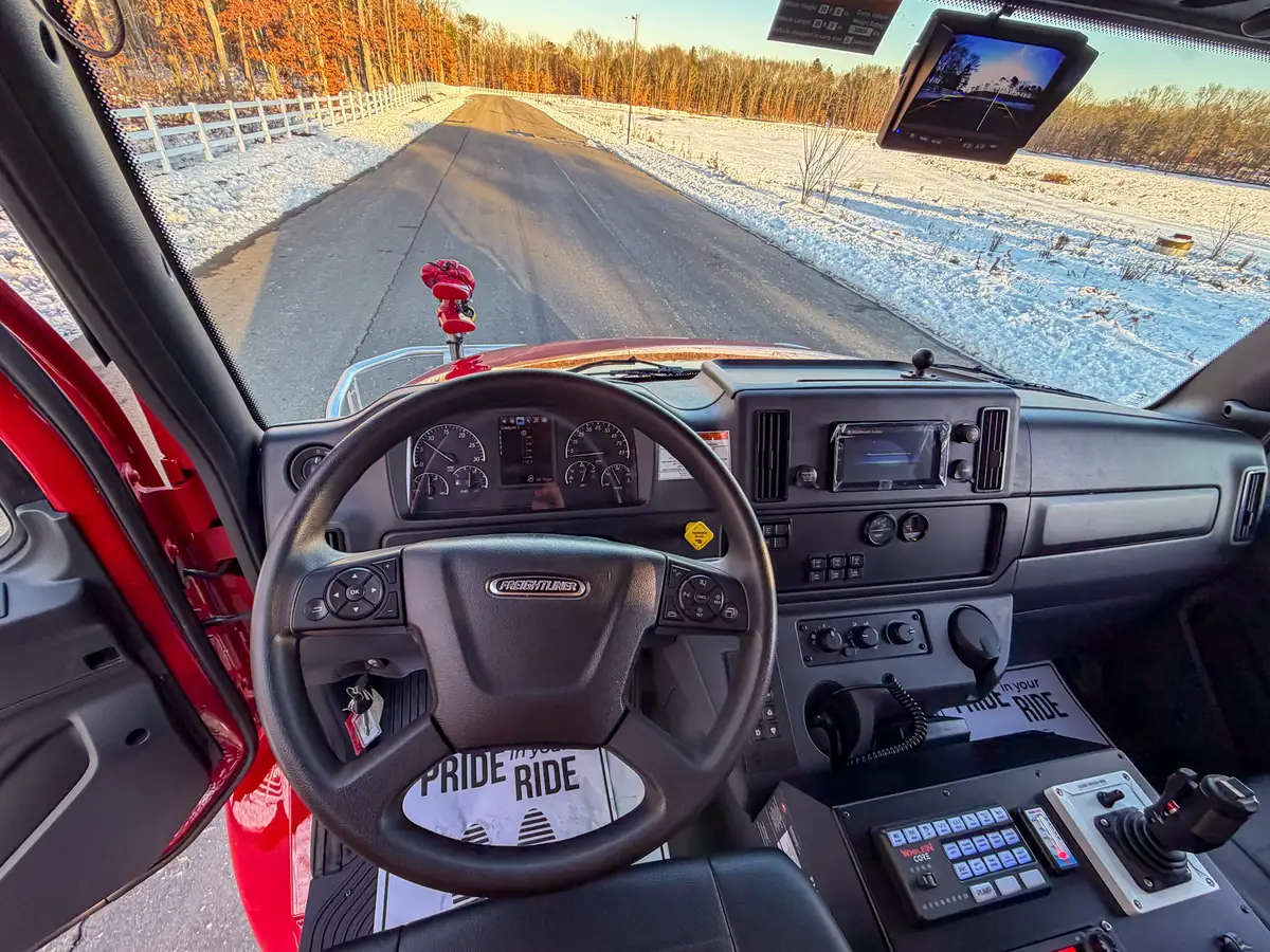 Wide interior view showing overhead storage, dashboard, and center control console.