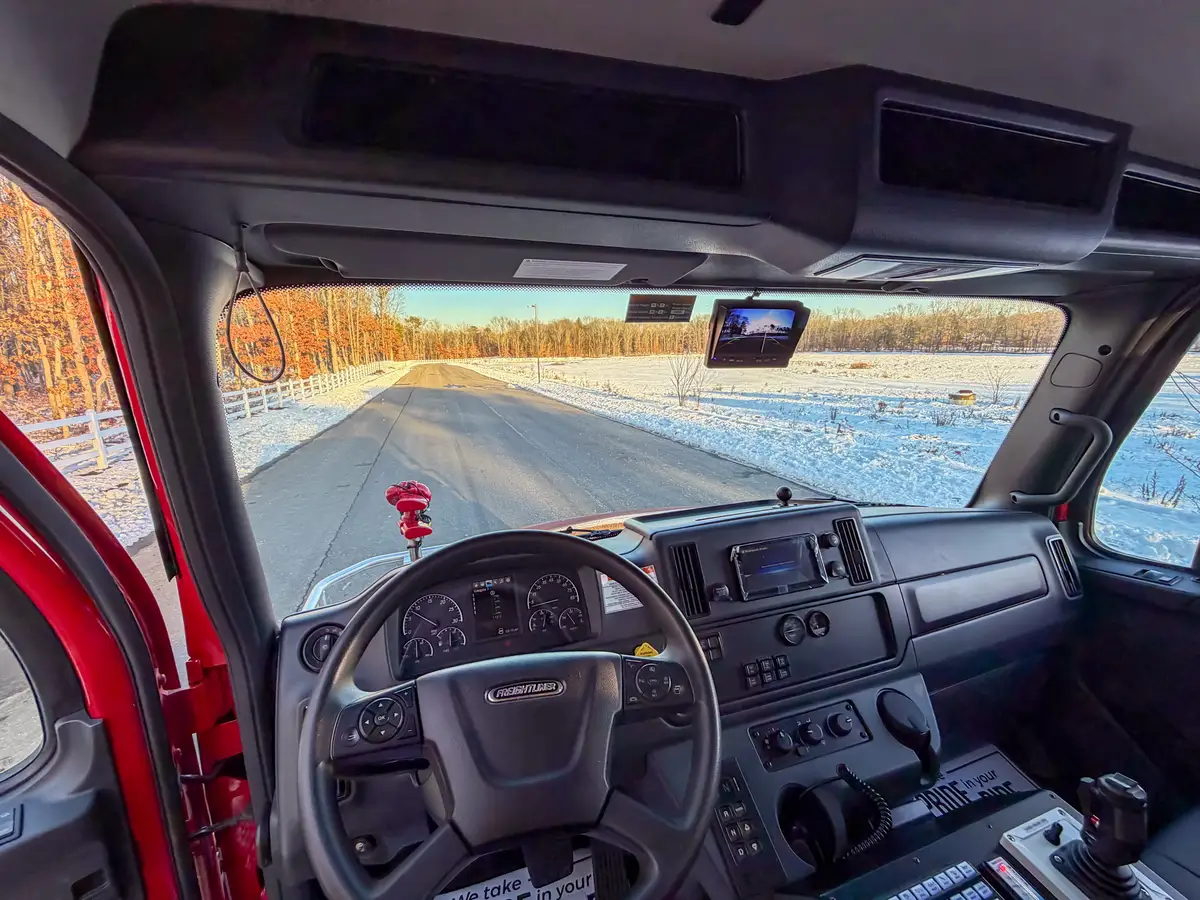 Interior close-up under center console showing fluid data label and seat base hardware.