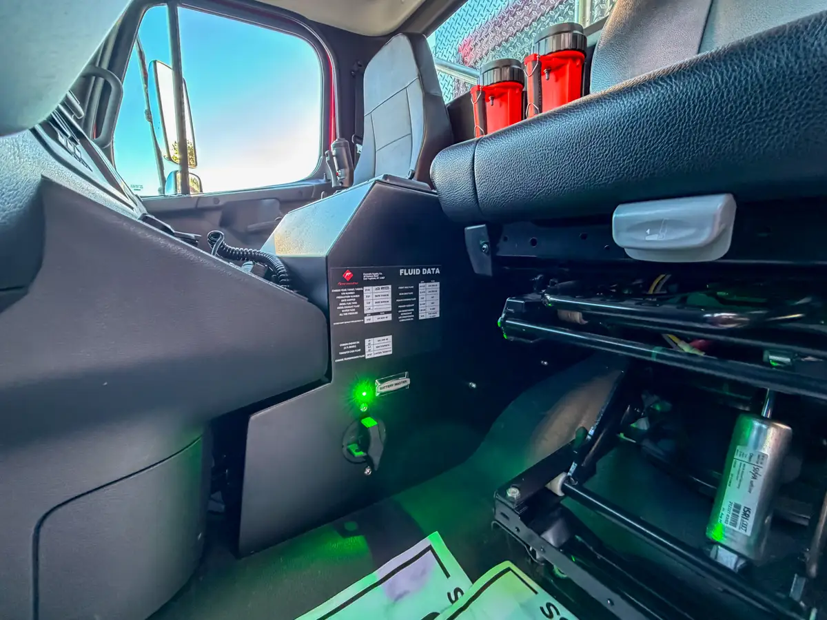 Exterior right-side view with cab door open and front wheel area visible.