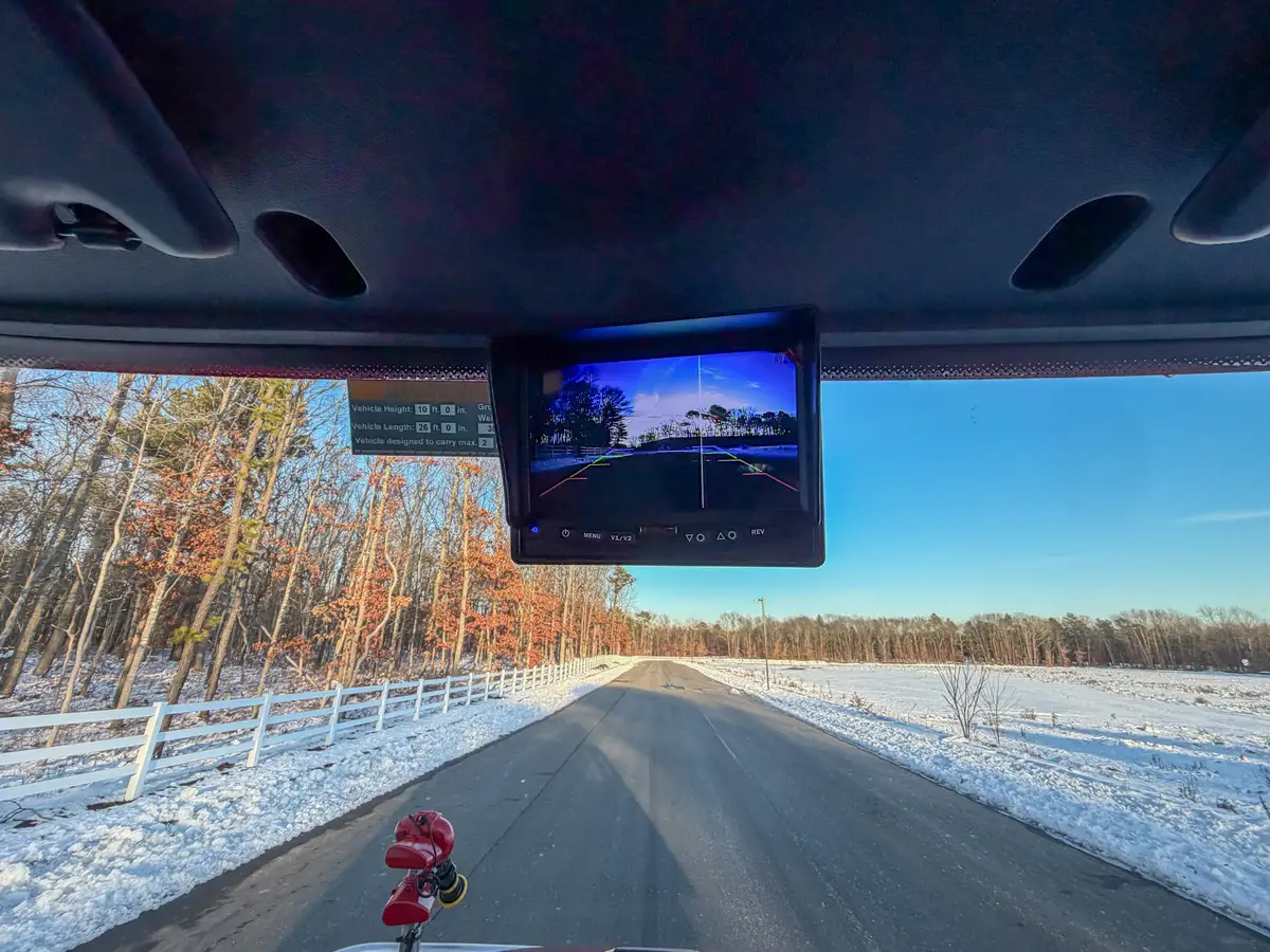 Interior side view with rear wall flashlight holders and passenger seat.