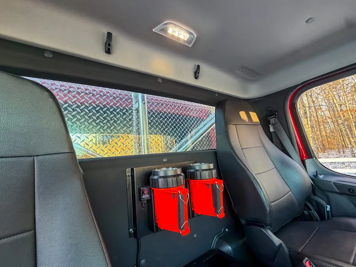 Interior wide view with steering wheel, dashboard, and overhead storage bins.