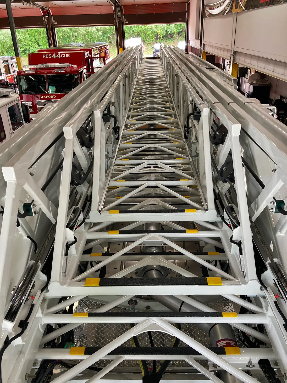 Top view along aerial ladder sections showing rungs and extension rails