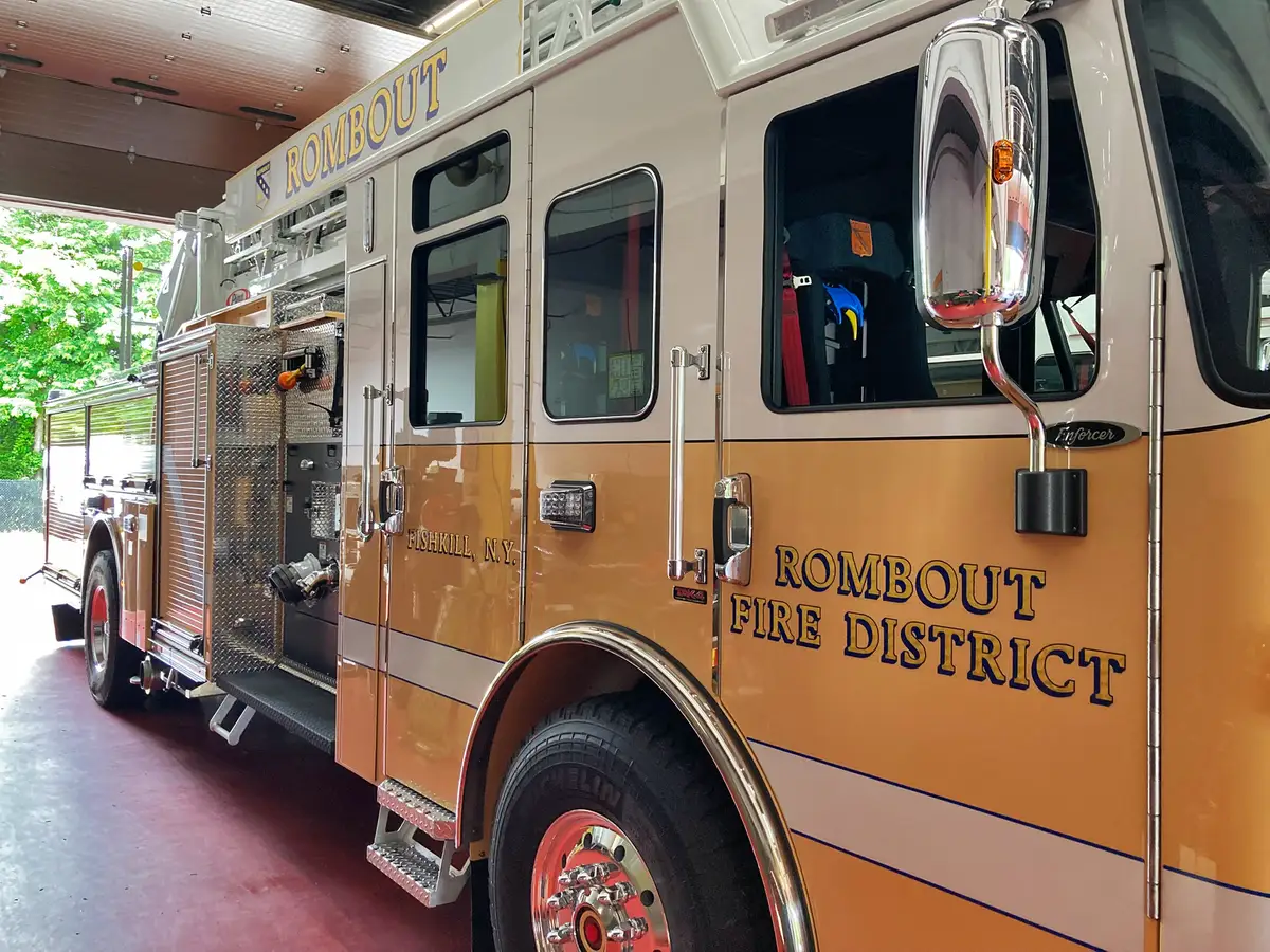 Cab side close-up showing door lettering, side windows, and mirror assembly