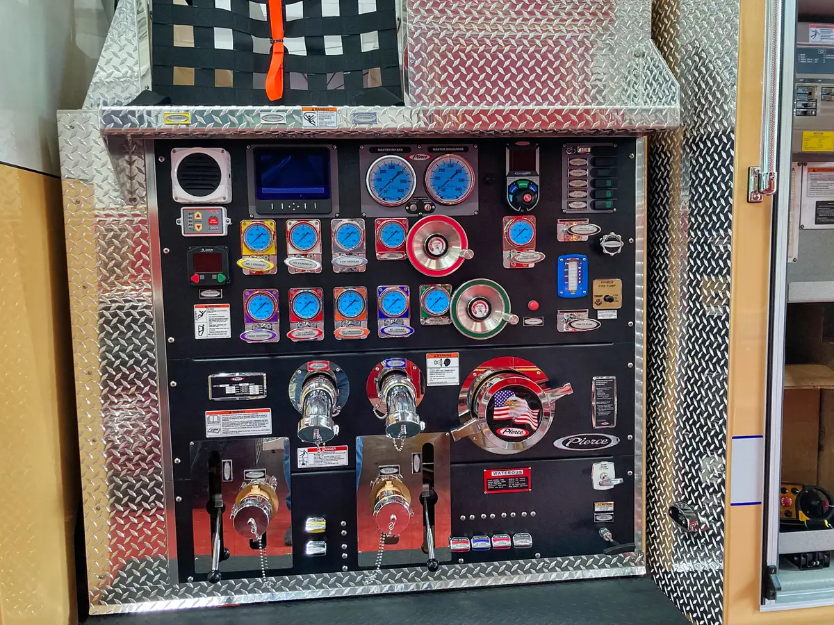Pump panel close-up showing gauges, valves, and large intake connections