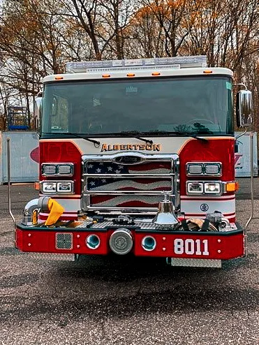 Front exterior view showing grille, bumper, and warning lights