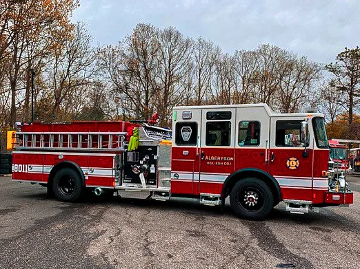 Driver-side profile view showing exposed pump panel, wheel area, and long tank body