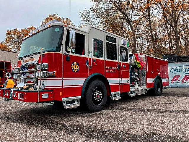 Front-right three-quarter view showing cab, front wheel, and side compartments
