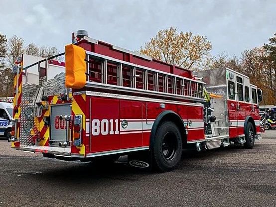 Passenger-side rear three-quarter view showing long side hosebed and rear body