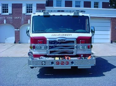 Front exterior view showing grille, bumper, and warning lights
