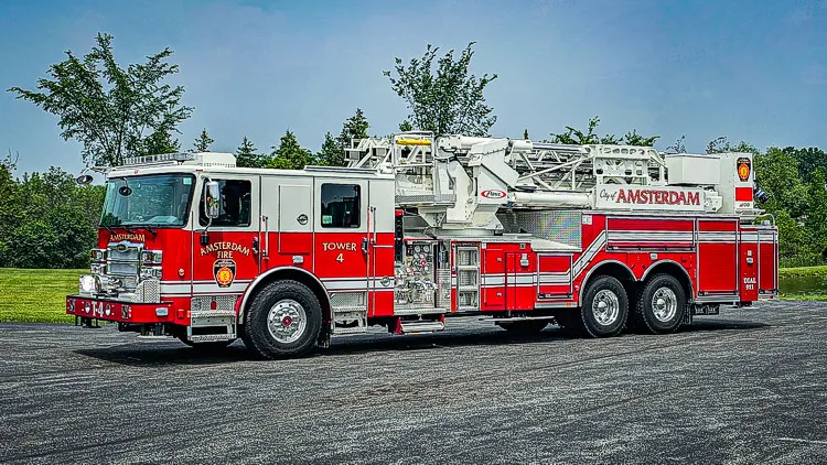 Driver-side full profile showing ladder bed and tandem rear axles
