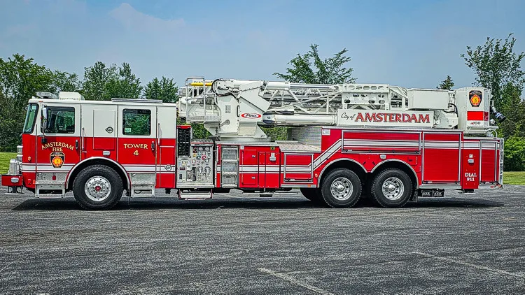 Driver-side full profile view showing tower ladder body and side compartments