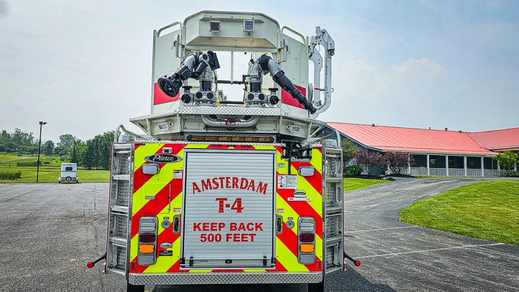 Rear view showing red-and-yellow chevrons and bucket platform above