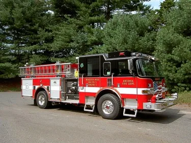 Front-right exterior view showing cab, side compartments, and wheel area