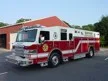 Wide front left view of the parked rescue truck with bumper, cab, and full body length.
