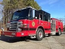 Wide front-left thumbnail view of the pumper parked roadside with full side body visible.