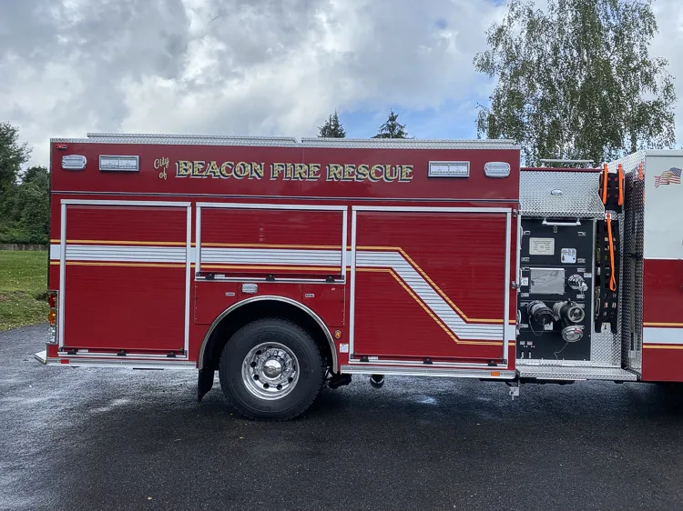 Driver-side profile view showing closed side compartments and rear body