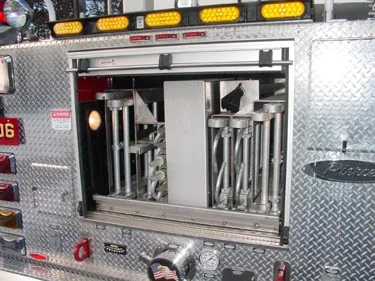 Rear compartment close-up showing open ladder-storage rack in tailboard section