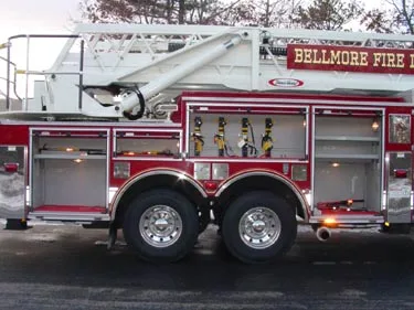 Driver-side profile showing tower ladder body and tandem rear axles