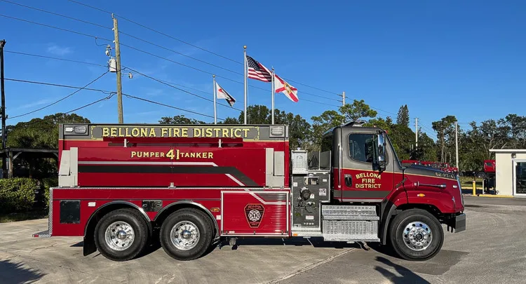 Driver-side full profile view showing tanker body and tandem rear axles