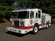 Pumper front-left exterior view showing enclosed cab and side compartments