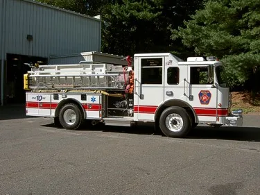 Passenger-side full profile showing side hosebed rails and wheel area