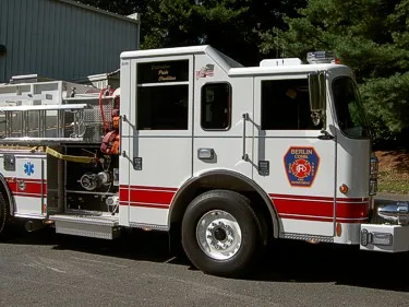 Passenger-side cab close-up showing door logo and rear wheel area