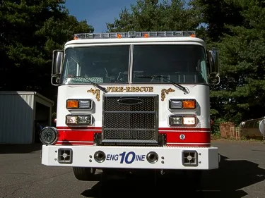 Front exterior view showing grille, bumper, and warning lights