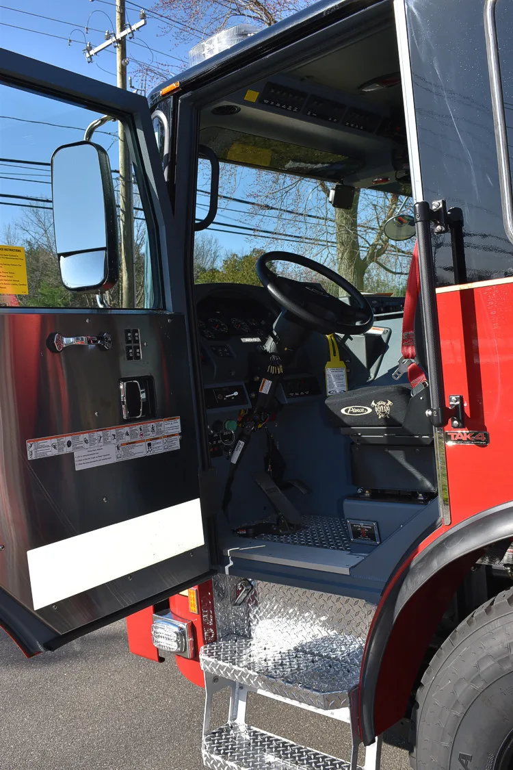 Cab door open view showing stepwell and lower interior trim