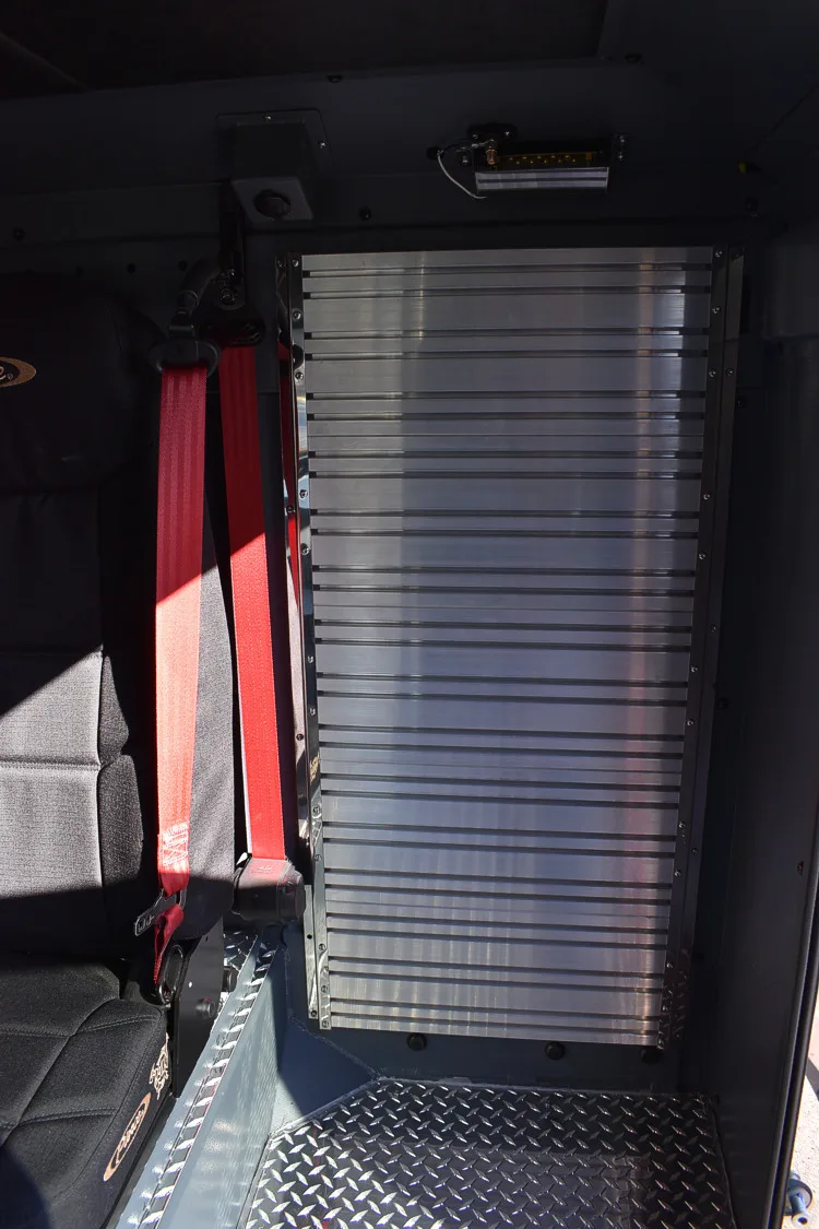 Cab interior rear view showing folded seat section and aisle space