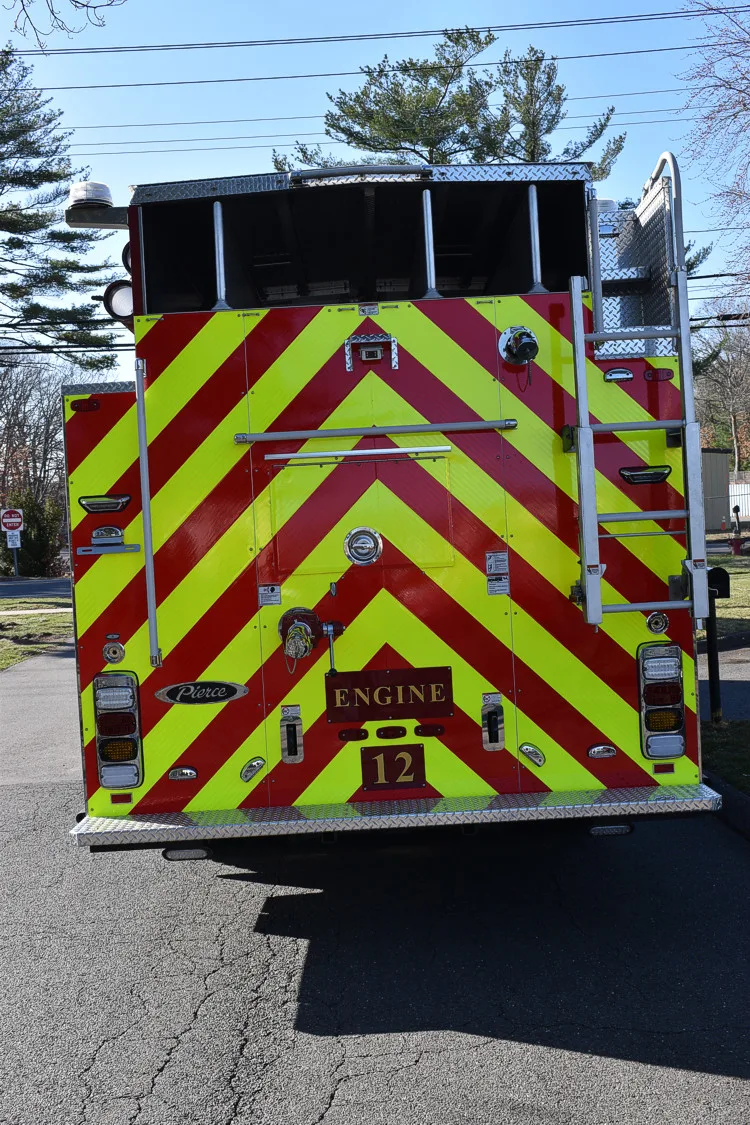 Rear view showing red-and-yellow chevrons and ladder access section