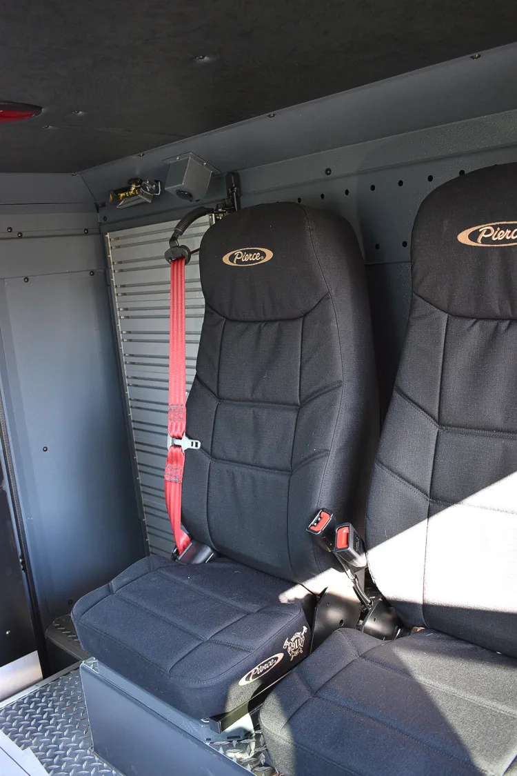 Cab interior close-up showing rear seat cushions and restraint straps