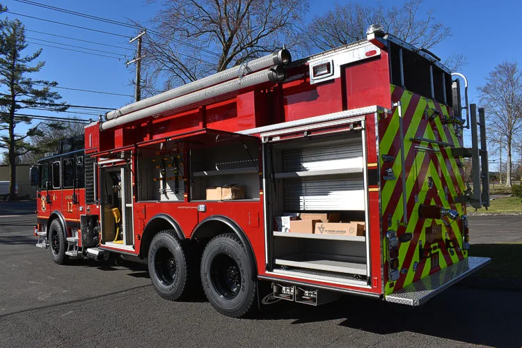Driver-side profile with open rear compartment showing storage bay