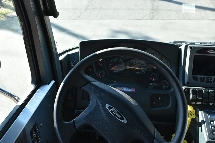 Driver cockpit view showing steering wheel, dashboard, and center controls
