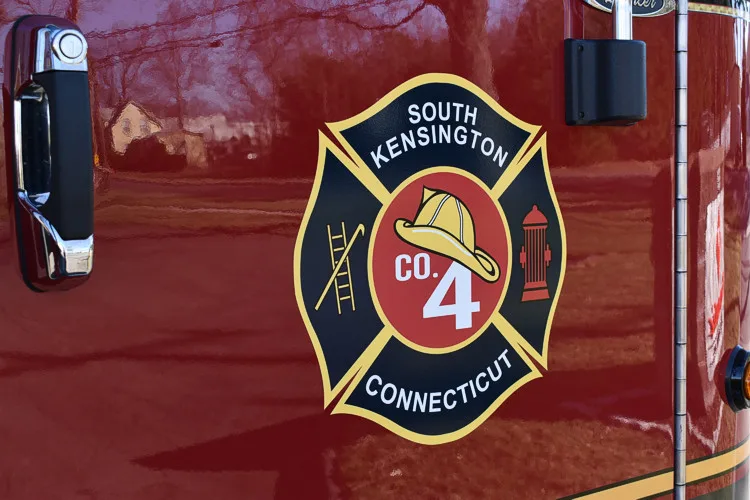 Cab door close-up showing shield-style crest and side handle