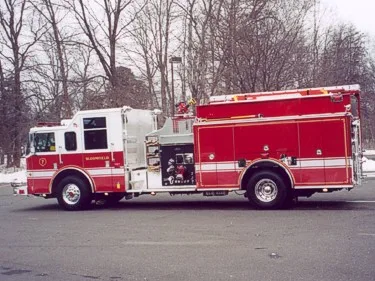 Driver-side profile view showing side compartments and midship pump controls