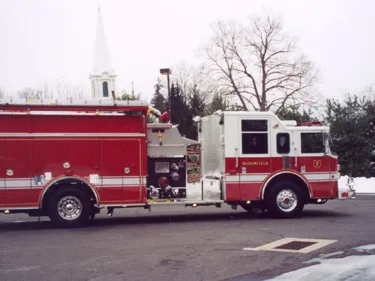 Passenger-side profile view showing side body compartments and front wheel area