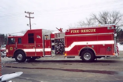 Driver-side profile view showing long rescue body and pump panel area