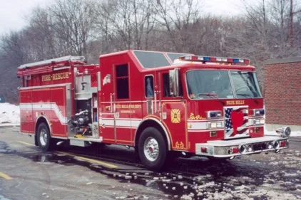 Front-left exterior view showing cab, bumper, and side body compartments