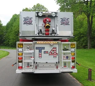 Straight rear view showing rear warning lights, rear panel, and bucket waterway fittings above.