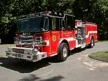 Pumper front-left exterior view showing enclosed cab and side compartments