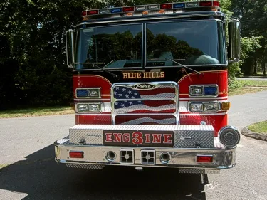 Front exterior view showing grille, bumper, and warning lights