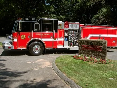 Driver-side profile view showing pump panel area and side compartments