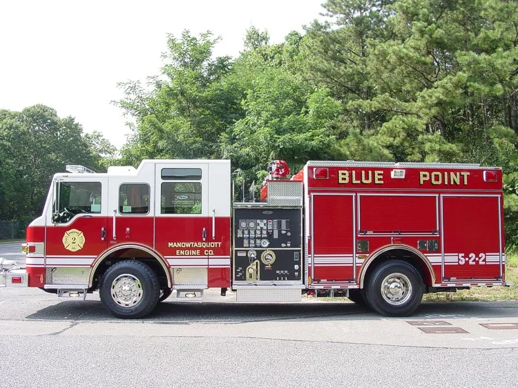 Driver-side profile showing exposed pump panel controls, side body compartments, and rear wheel.