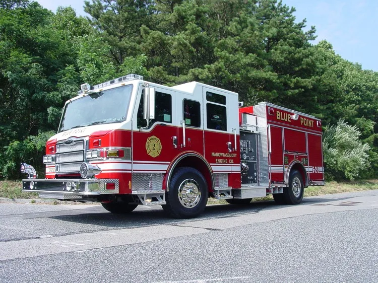 Front-right wide view showing the pumper cab, grille, and side body profile.