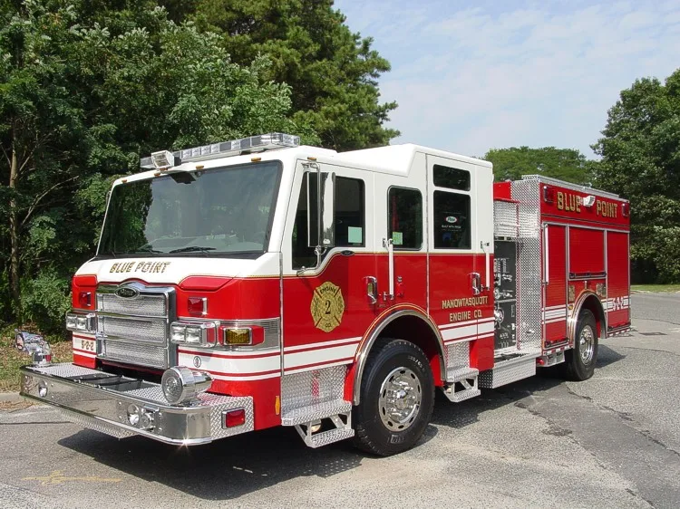 Front-right close view showing grille, bumper, warning lights, and side pump panel area.