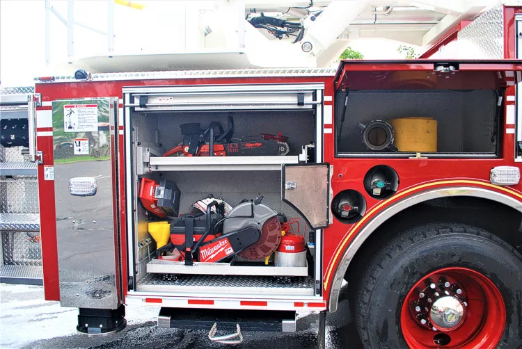 Open side compartment showing bags and tools near rear wheel area