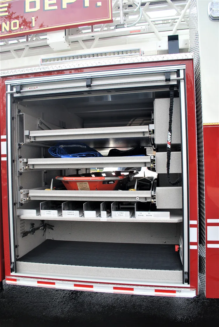 Open side compartment showing slide-out tray and shelf-mounted tools