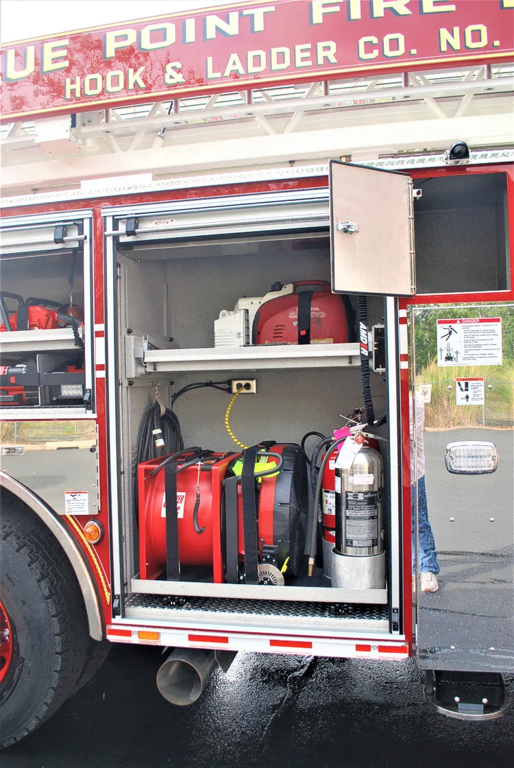Open side compartment showing extinguishers and tool storage bins